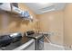 Laundry room with modern washer and dryer, shelving, and an ironing board at 7414 Glen Park Way, Indianapolis, IN 46259