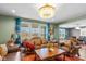 Comfortable living room featuring large windows, luxury chandelier, and rich hardwood floors at 7414 Glen Park Way, Indianapolis, IN 46259