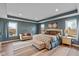 This main bedroom features a decorative area rug, tray ceilings and plenty of light at 7414 Glen Park Way, Indianapolis, IN 46259