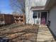 A fenced backyard with a chair, privacy fence, and exterior access at 8023 Xenia Dr, Indianapolis, IN 46227