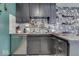 Galley kitchen with dark cabinetry and a corner sink at 8023 Xenia Dr, Indianapolis, IN 46227
