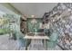Kitchen and dining area with floral wallpaper and green chairs at 8023 Xenia Dr, Indianapolis, IN 46227