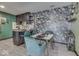 Kitchen and dining area with floral wallpaper and green chairs at 8023 Xenia Dr, Indianapolis, IN 46227