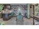 Kitchen and dining area with floral wallpaper and green chairs at 8023 Xenia Dr, Indianapolis, IN 46227