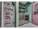 Laundry room with washer, dryer, and storage shelves at 8023 Xenia Dr, Indianapolis, IN 46227