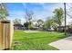 Well-maintained backyard with a concrete pad and a surrounding fence and various green trees at 1446 E Naomi St, Indianapolis, IN 46203