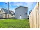 Well-maintained backyard with a gray exterior featuring a door and a window at 1446 E Naomi St, Indianapolis, IN 46203