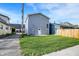 Well-maintained backyard with a gray exterior featuring a door and a window at 1446 E Naomi St, Indianapolis, IN 46203
