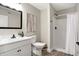 Clean bathroom with shower, toilet, and white vanity with countertop at 1446 E Naomi St, Indianapolis, IN 46203