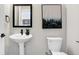 Small bathroom with pedestal sink and toilet at 1446 E Naomi St, Indianapolis, IN 46203