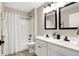 Modern bathroom with double vanity, white cabinets, and a tub at 1446 E Naomi St, Indianapolis, IN 46203