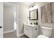 Small bathroom with white vanity, toilet and framed mirror at 1446 E Naomi St, Indianapolis, IN 46203