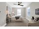 Cozy bedroom with ceiling fan, neutral decor, and carpeted floor at 1446 E Naomi St, Indianapolis, IN 46203