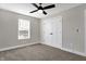 Bright bedroom with carpeted floor, window with blinds, and double doors to closet at 1446 E Naomi St, Indianapolis, IN 46203