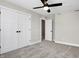 Empty bedroom with grey carpet, double doors, and ceiling fan at 1446 E Naomi St, Indianapolis, IN 46203