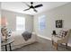 Spacious bedroom with carpeted floor, ceiling fan, and two windows at 1446 E Naomi St, Indianapolis, IN 46203