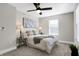 Bright bedroom with ceiling fan, neutral decor, and carpeted floor at 1446 E Naomi St, Indianapolis, IN 46203