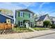 Charming two-story home featuring a vibrant green exterior with black shutters and a well-maintained front yard at 1446 E Naomi St, Indianapolis, IN 46203