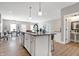 Modern kitchen with large island, stainless steel appliances, and breakfast bar at 1446 E Naomi St, Indianapolis, IN 46203