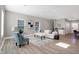 Open concept living room with hardwood floors, white couch, and blue chairs at 1446 E Naomi St, Indianapolis, IN 46203