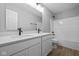 Modern bathroom featuring double sink vanity, quartz counters, and tub with shower at 1713 Real St, Indianapolis, IN 46240