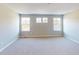 Bright bedroom features three windows for natural light and plush carpeting at 1713 Real St, Indianapolis, IN 46240