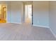 Neutral bedroom features plush carpet and leads to an en-suite bathroom at 1713 Real St, Indianapolis, IN 46240