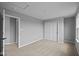 Well-lit bedroom with neutral carpeting, light gray walls, closet, and natural light at 1713 Real St, Indianapolis, IN 46240