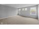 Bedroom with neutral carpet and paint. The windows offer lots of natural light and views of the trees at 1713 Real St, Indianapolis, IN 46240