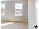 Sunlit bedroom with a view from its windows and neutral colored walls and carpeting at 1713 Real St, Indianapolis, IN 46240
