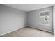 Bright bedroom with neutral carpeting, light gray walls, and window at 1713 Real St, Indianapolis, IN 46240