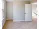 Bright bedroom featuring neutral carpeting and paint, with a window providing natural light at 1713 Real St, Indianapolis, IN 46240