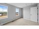 Inviting bedroom featuring neutral carpeting, light gray walls, and large windows at 1713 Real St, Indianapolis, IN 46240