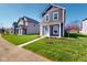 Well maintained lawn with a sidewalk leading to a charming two-story home at 1713 Real St, Indianapolis, IN 46240