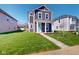 Beautiful two-story home featuring green grass, neat landscaping, and an inviting entrance way at 1713 Real St, Indianapolis, IN 46240