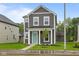 Charming two-story home with gray siding, white trim, and a welcoming turquoise front door at 1713 Real St, Indianapolis, IN 46240