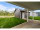 View of the detached garage and backyard, with lush green grass and blue sky at 1713 Real St, Indianapolis, IN 46240