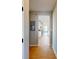 Hallway with wood-look flooring, offering a view into the kitchen and natural light at 1713 Real St, Indianapolis, IN 46240