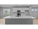 Modern kitchen with white cabinets, quartz countertops, stainless steel appliances and hardwood floors at 1713 Real St, Indianapolis, IN 46240