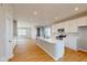 Modern kitchen features an island, white cabinets, stainless steel appliances and wood flooring at 1713 Real St, Indianapolis, IN 46240