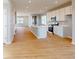 Open concept kitchen with island, stainless steel appliances, and hardwood floors throughout the home at 1713 Real St, Indianapolis, IN 46240