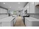 Modern kitchen with white cabinets, quartz countertops, stainless steel appliances and hardwood floors at 1713 Real St, Indianapolis, IN 46240