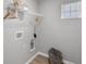 Well-organized laundry room featuring white wire shelving, a hanging rod, and a modern gray basket for storage at 1713 Real St, Indianapolis, IN 46240