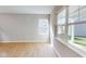 Sunlit living room with wood-look floors and large windows offering a view of the yard at 1713 Real St, Indianapolis, IN 46240