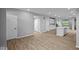 Open-concept living space with hardwood floors and neutral paint, leading to a modern kitchen at 1713 Real St, Indianapolis, IN 46240