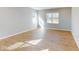 Spacious living room featuring wood-look floors and plenty of natural light from multiple windows at 1713 Real St, Indianapolis, IN 46240