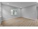 Bright living room featuring wood-look floors, neutral paint, recessed lighting, and a large window for plenty of natural light at 1713 Real St, Indianapolis, IN 46240