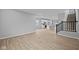 Spacious living room featuring hardwood floors, neutral paint, a staircase, and a modern kitchen at 1713 Real St, Indianapolis, IN 46240