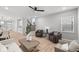 Comfortable living room showcasing neutral-toned furniture, a stylish ceiling fan, and plenty of natural light at 1713 Real St, Indianapolis, IN 46240