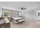 Well-lit main bedroom with carpet, a ceiling fan, and windows with blinds at 1713 Real St, Indianapolis, IN 46240